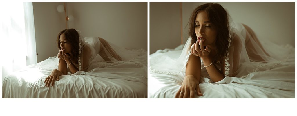 woman in boudoir studio wearing a bridal veil posing on bed